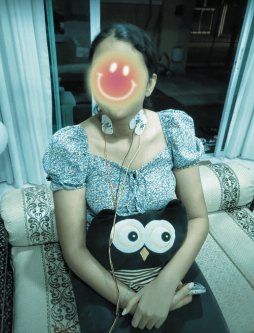 A patient at Tan Tock Seng Hospital using Neural Drive from their bedside